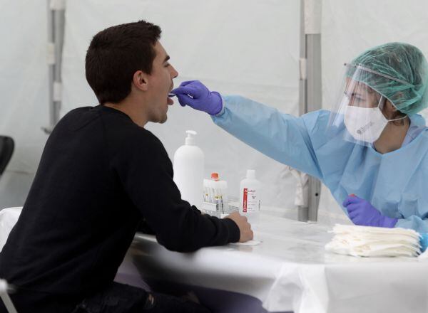 Una sanitaria le realiza un frotis bucal a un vecino de Ordizia para realizar test ante el posible brote de COVID-19 detectado en la localidad guipuzcoana, en Ordizia, Guipúzcoa, País Vasco (España), a 6 de julio de 2020