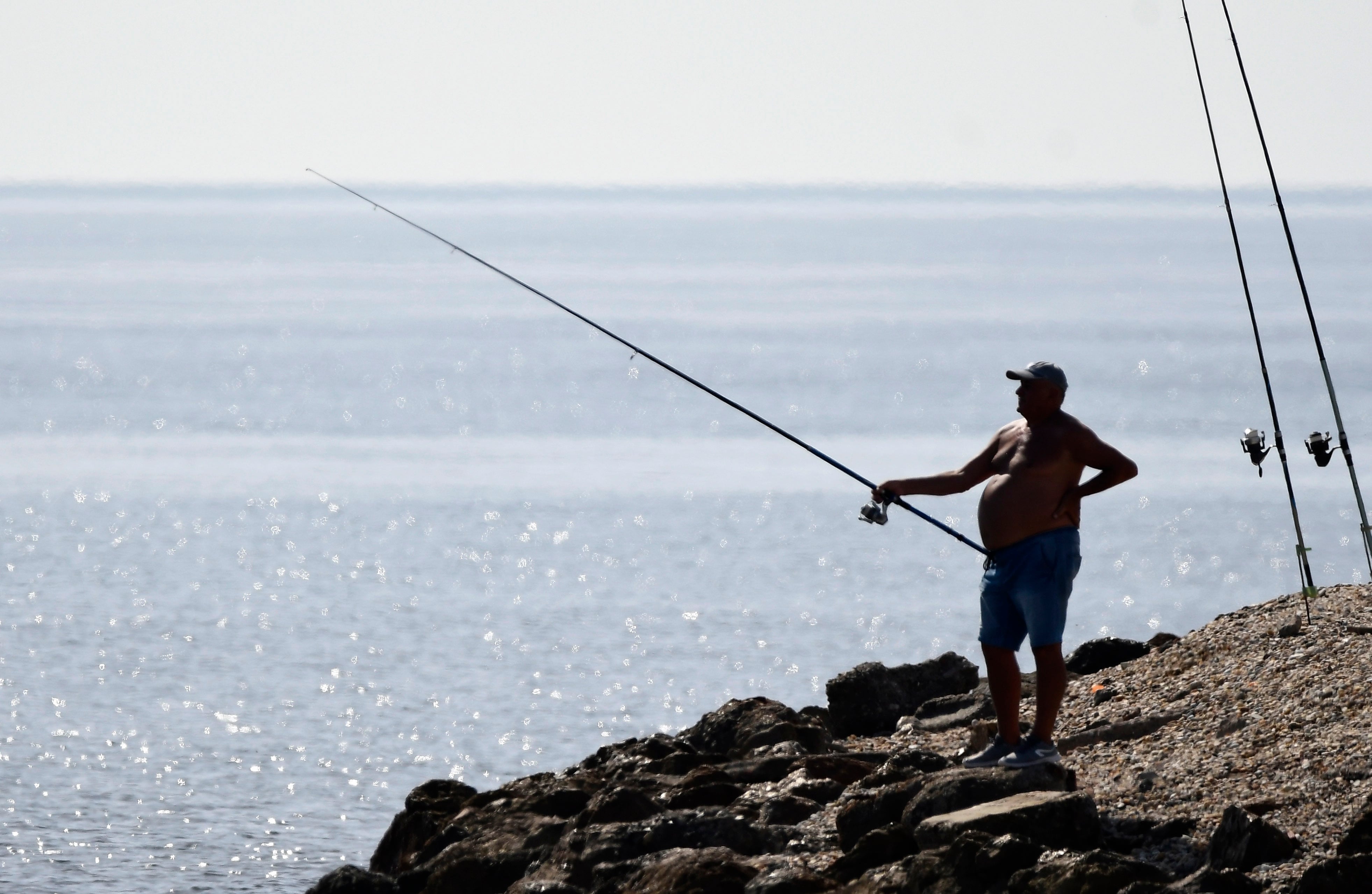 Una persona pesca junto a la desembocadura del rio Andarax (Almería), este viernes