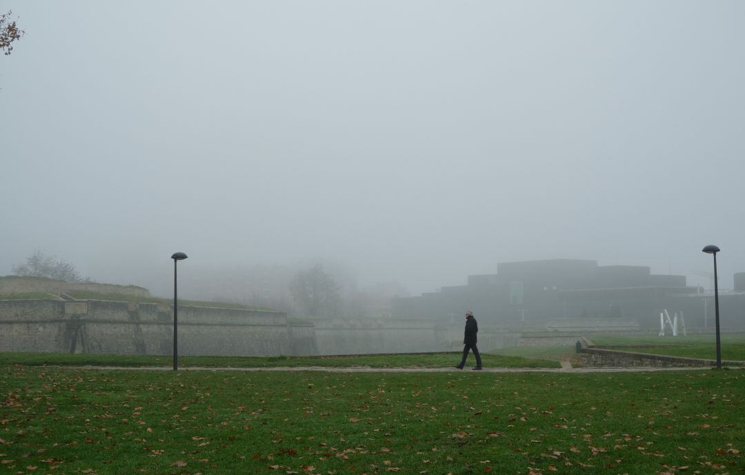 Un hombre camina entre la niebla en el parque Vuelta del Castillo, en Pamplona, el pasado mes de diciembre.