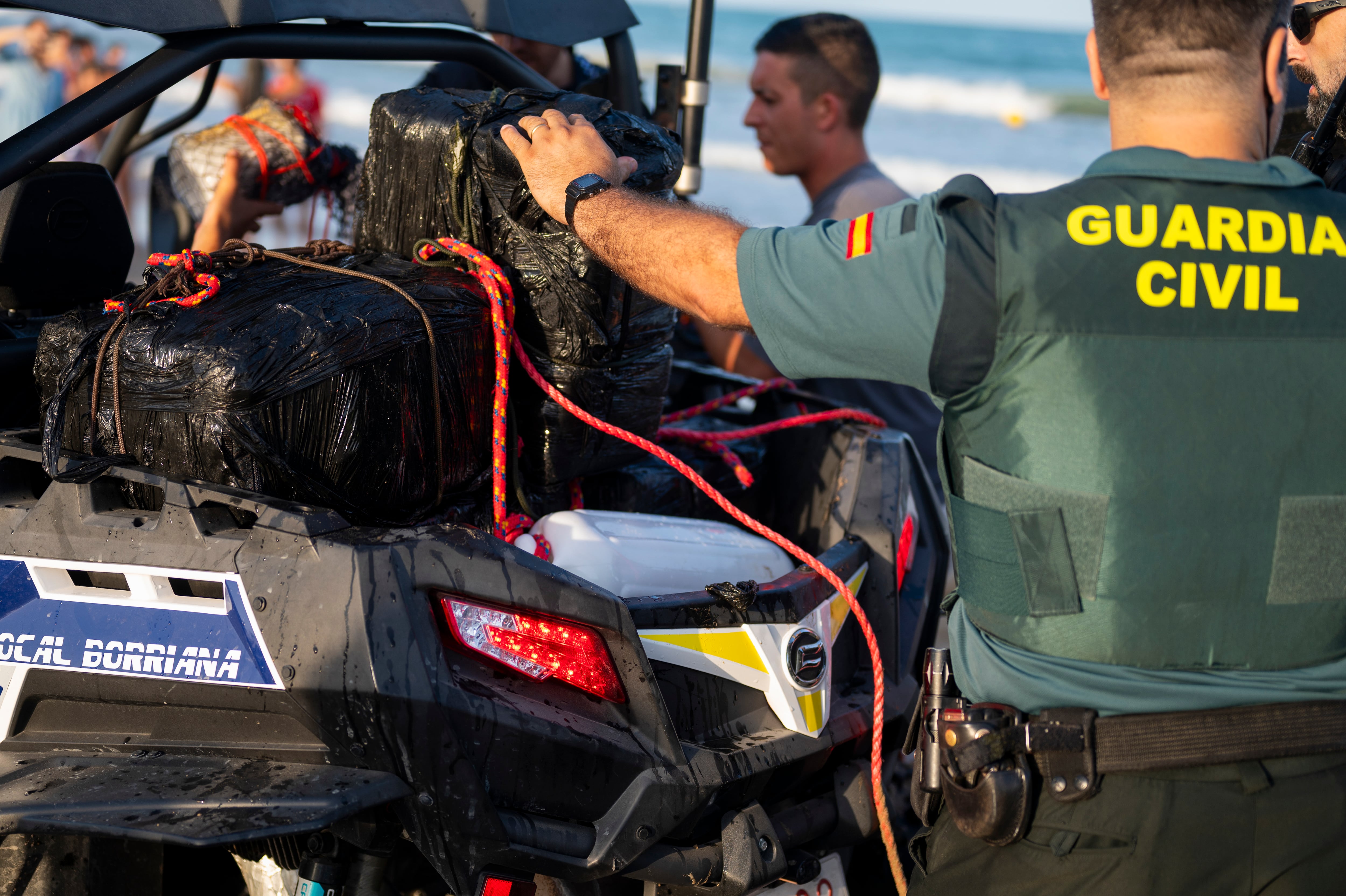 GRAFCVA1924. BURRIANA (CASTELLÓN), 17/07/2024.- Agentes de la Guardia Civil han retirado de la playa del Arenal de Burriana más de una decena de fardos negros que han sido acercados a la orilla por efectivos de Salvamento Marítimo tras haber sido hallados enganchados a una boya. EFE/Andreu Esteban
