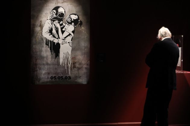 Un hombre contempla una de las obras que forma parte de la exposición ‘Banksy. The Street is a Canvas’ en el Círculo de Bellas Artes  en Madrid