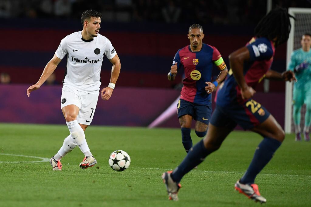 Raphinha of FC Barcelona in action against Filip Ugrinic of Young Boys during the UEFA Champions League football match between FC Barcelona and Young Boys at the Estadi Olimpic Lluis Companys in Barcelona, Spain on October 1, 2024. (Photo by Adria Puig/Anadolu via Getty Images)