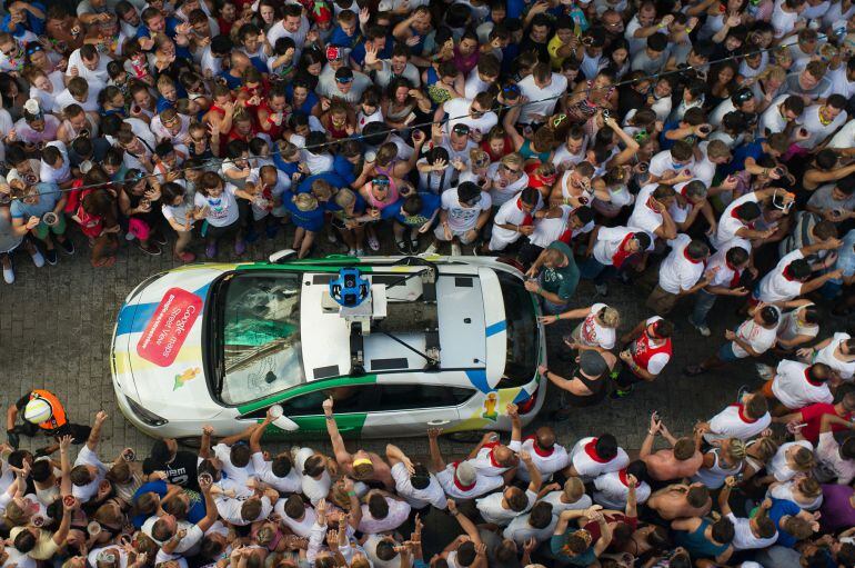 BUNOL, SPAIN - AUGUST 26:  A Google Street View car drives through revellers during the annual Tomatina festival on August 26, 2015 in Bunol, Spain. An estimated 22,000 people threw 150 tons of ripe tomatoes in the world's biggest tomato fight held annually in this Spanish Mediterranean town.  (Photo by David Ramos/Getty Images)