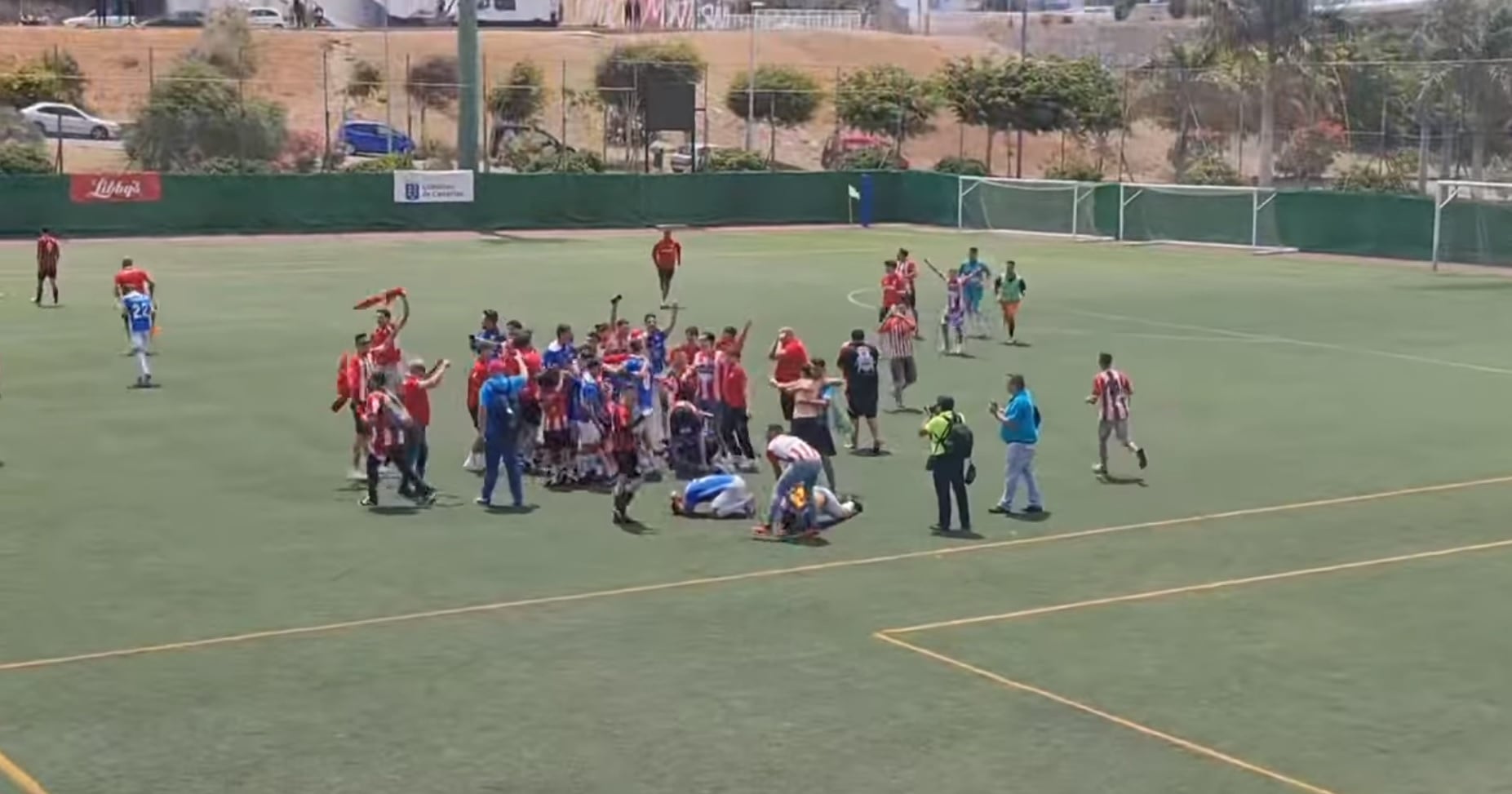 Jugadores y aficionados del San Bartolomé CF celebrando el ascenso en el campo del Unión Viera.