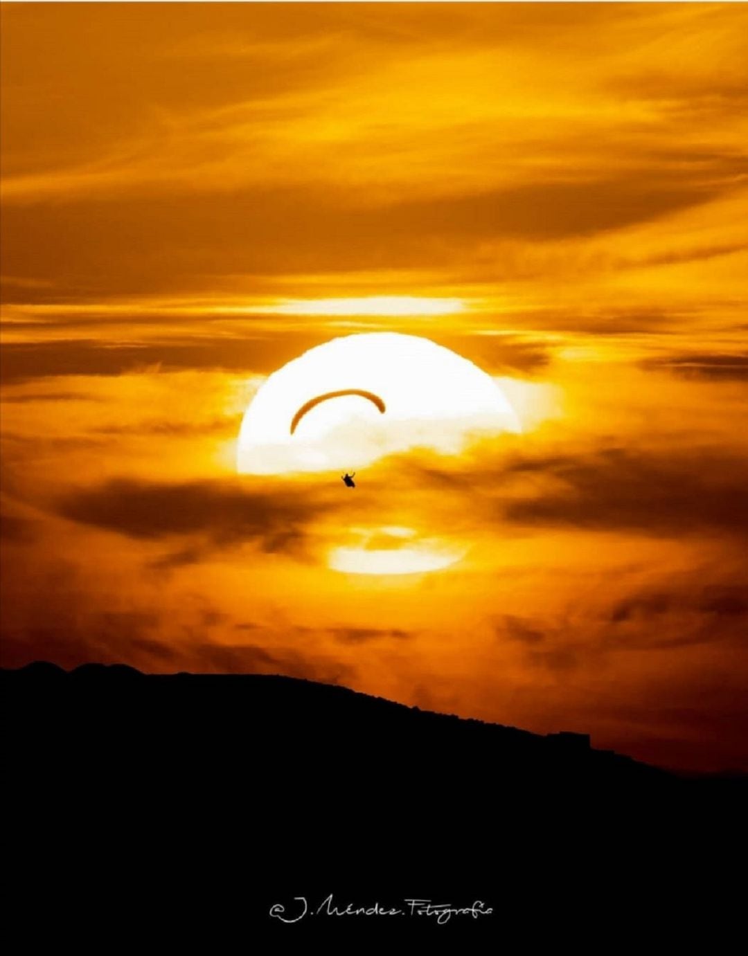 El fotógrafo captó en la instantánea a un parapentista contra el Sol en Lanzarote. 