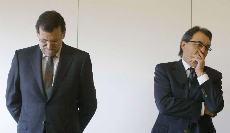 Catalonia's Regional President Artur Mas (R) stands next to Spain's Prime Minister Mariano Rajoy at Sants train station in Barcelona before the inaugural trip of Spain's newest high speed train service from Barcelona to Figueres, January 8, 2013.  The wealthy northeastern region of Catalonia last month dropped plans for a non-binding referendum on independence from Spain on Nov. 9 after a court declared such a vote against the constitution and had instead planned to hold a "consultation of citizens" on the same day. Although Spanish Prime Minister Mariano Rajoy and politicians in Catalonia have called for dialogue over the region's status after the initial referendum plans were abandoned, tensions are still simmering before the Nov. 9 alternative vote. Picture taken January 8, 2013.   REUTERS/Albert Gea (SPAIN 
 
  - Tags: POLITICS)
 
 ATTENTION EDITORS: PICTURE 12 OF 25 FOR WIDER IMAGE PACKAGE 'CATALONIA - THE CONSULTATION OF CITIZENS'
 TO FIND ALL IMAGES SEARCH 'CITIZENS'