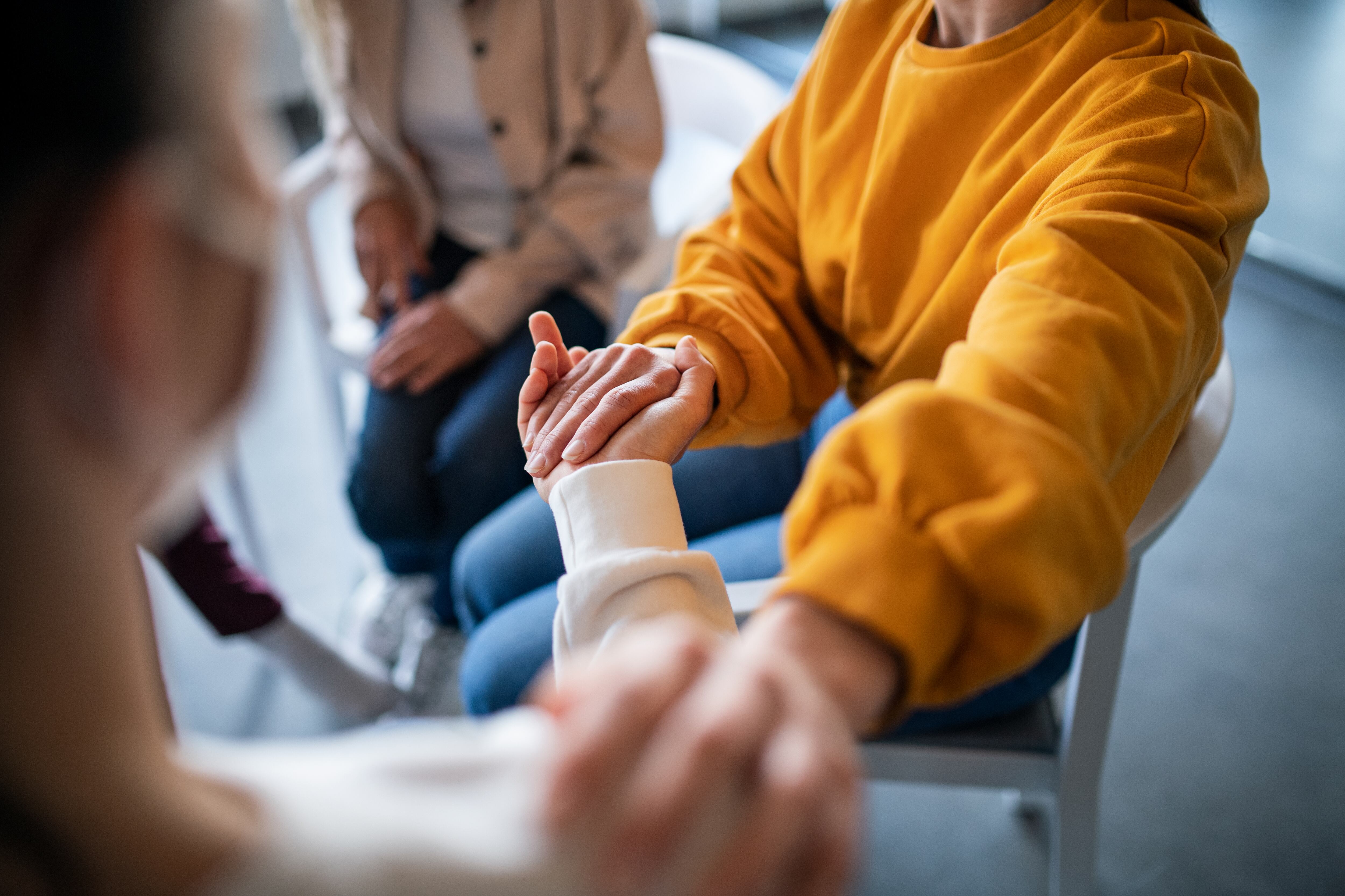 People supporting one another on grief therapy session.