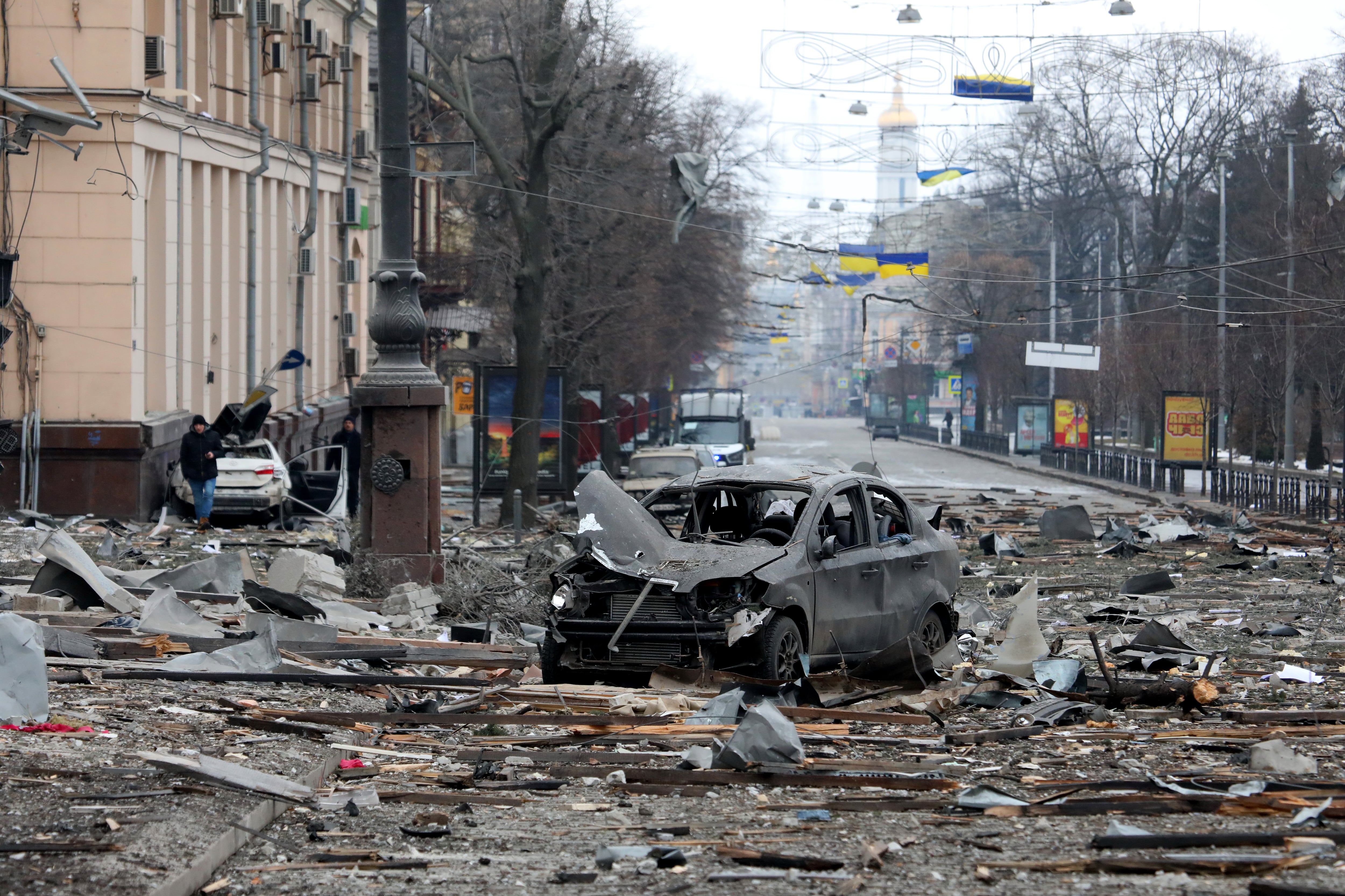 KHARKIV, UKRAINE - MARCH 1, 2022 - A burnt-out car is seen on the street after a missile launched by Russian invaders hit near the Kharkiv Regional State Administration building in Svobody (Freedom) Square) at approximately 8 am local time on Tuesday, March 1, Kharkiv, northeastern Ukraine. (Photo credit should read Vyacheslav Madiyevskyy/ Ukrinform/Future Publishing via Getty Images)