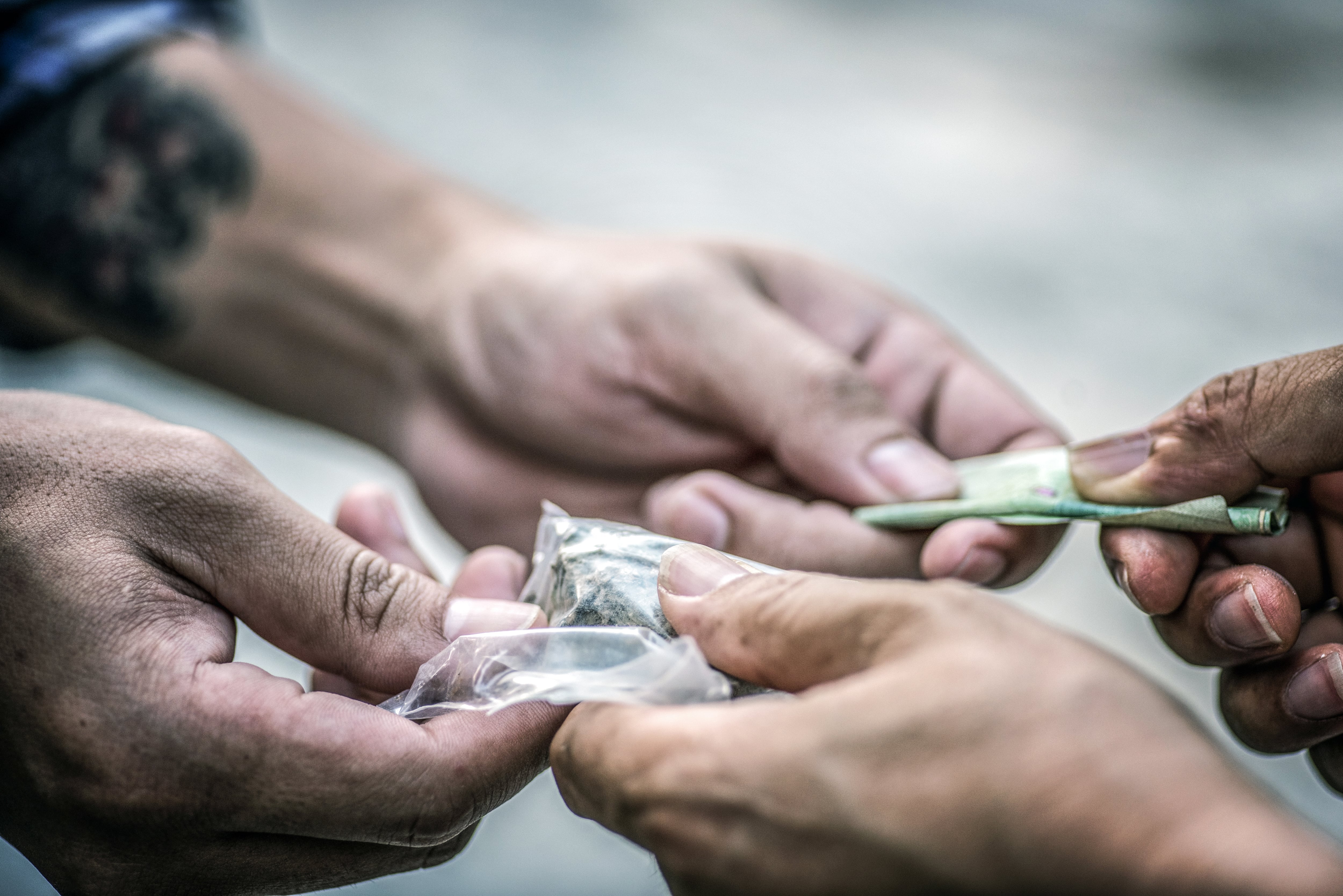 Drug addict buying narcotics and paying.