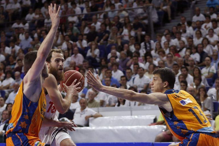 GRA411. MADRID, 04/06/2015. El base del Real Madrid Sergio Rodríguez (c) pugna un balon con el belga Sam Van Rossom (i) y el serbio Vladimir Lucic (d), del Valencia Basket, durante el primer partido de las semifinales de la Liga ACB que se juega esta tarde en el Palacio de los Deportes de la Comunidad de Madrid. EFE/Javier Lizón