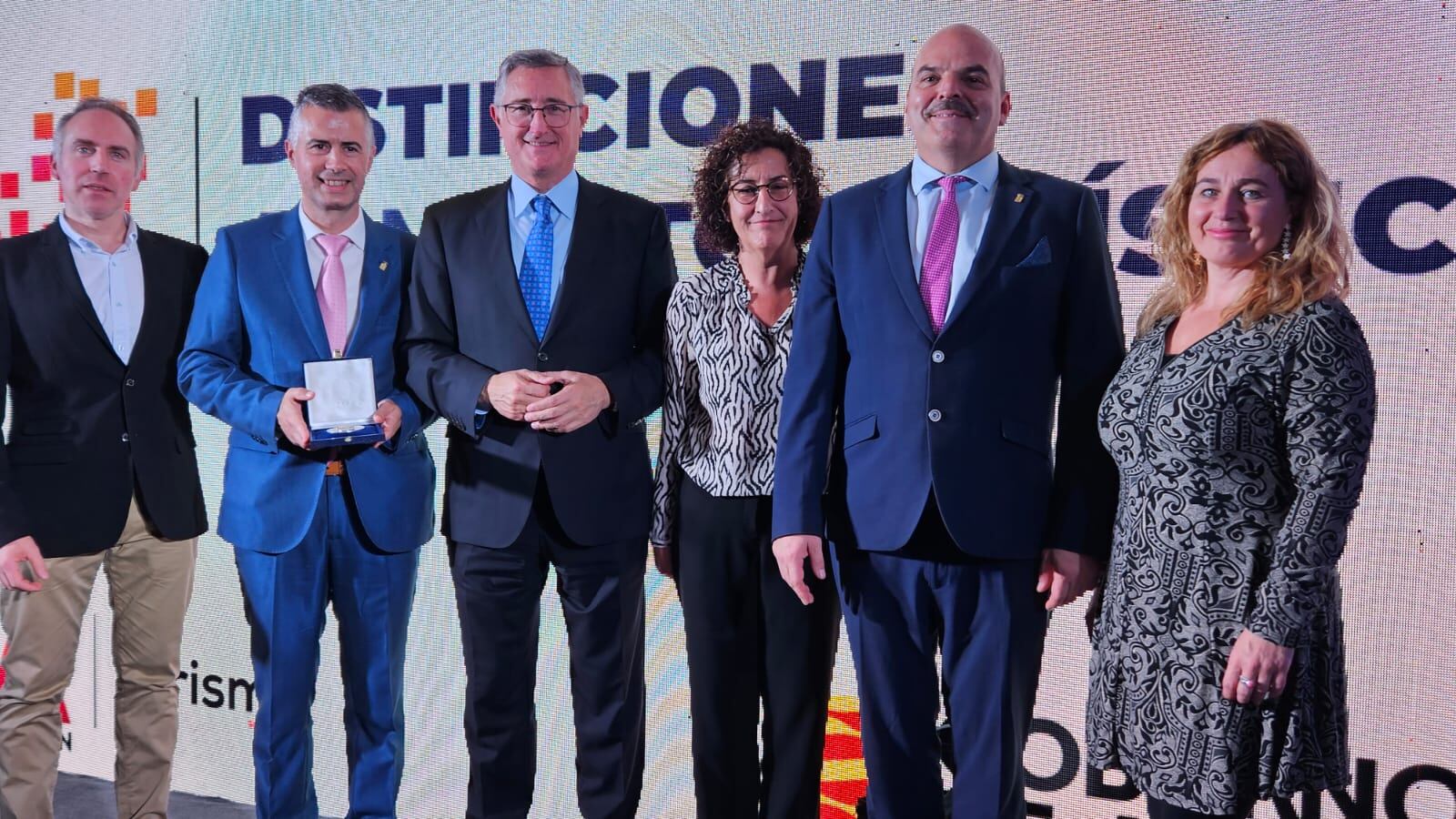 Delegación jacetana en la entrega de la Medalla al Mérito Turístico al Festival Folklórico de los Pirineos, junto al consejero de Turismo (centro)