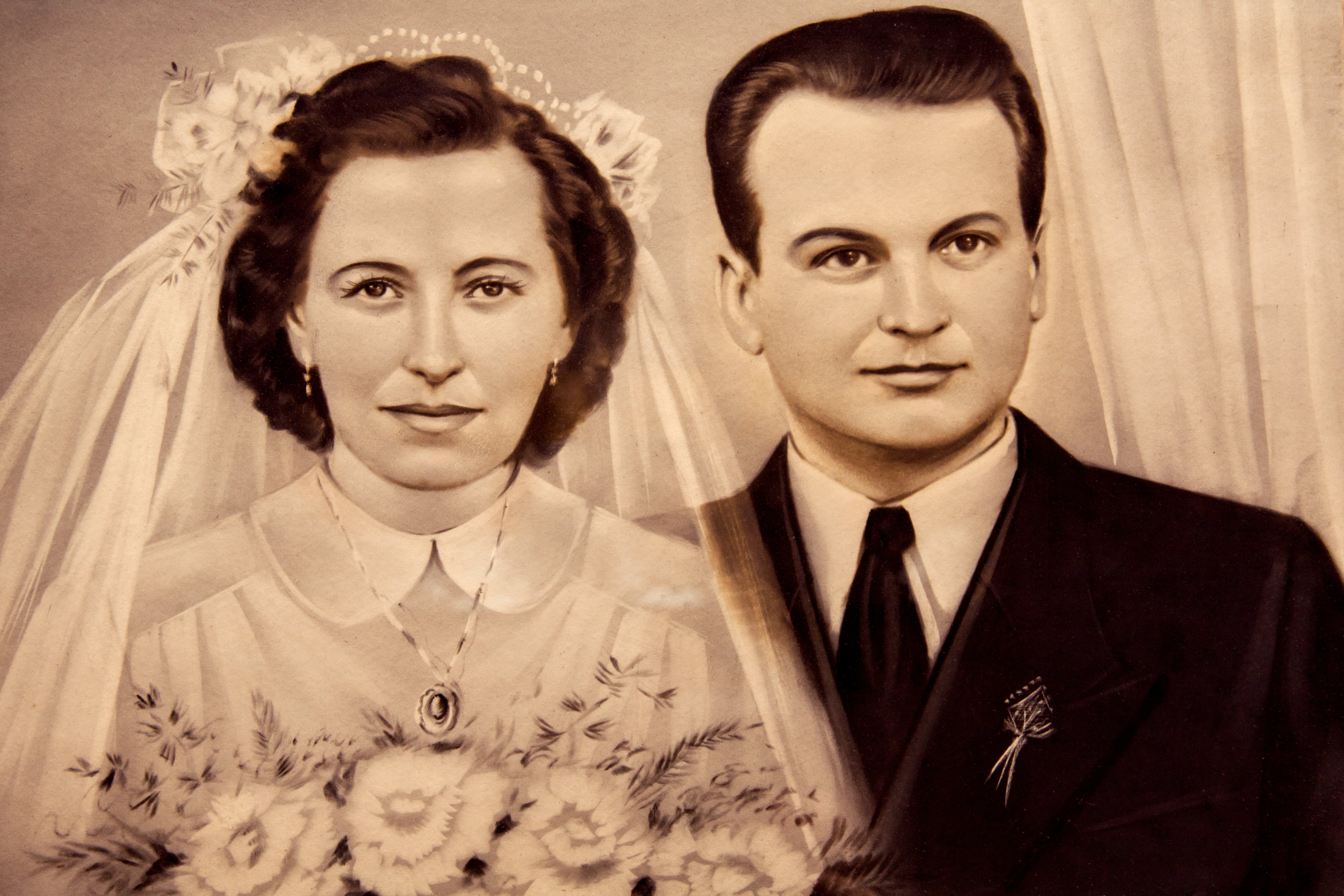 1950s original vintage photo of the young Romanian couple on a wedding day. Sepia-toned desaturated color.