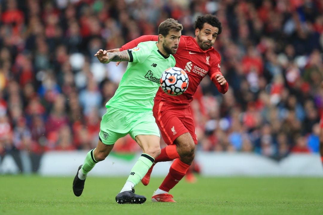 Inigo Martinez of Athletic Club battles with Mohamed Salah of Liverpool during the pre-season friendly match between Liverpool and Athletic Club at Anfield on August 8, 2021 in Liverpool, England