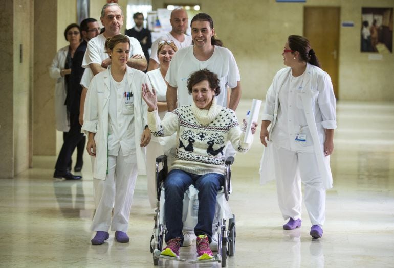 FILE - In this Wednesday, Nov. 5, 2014 file photo, Teresa Romero, bottom right, arrives with medical workers to give a press statement before she leaves the Carlos III hospital in Madrid, Spain. A Spanish nursing assistant who recovered from Ebola has bee