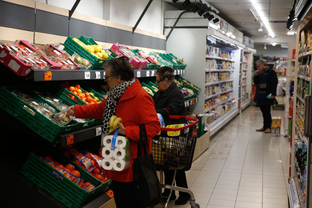 Varias personas hacen la compra en un supermercado en Madrid