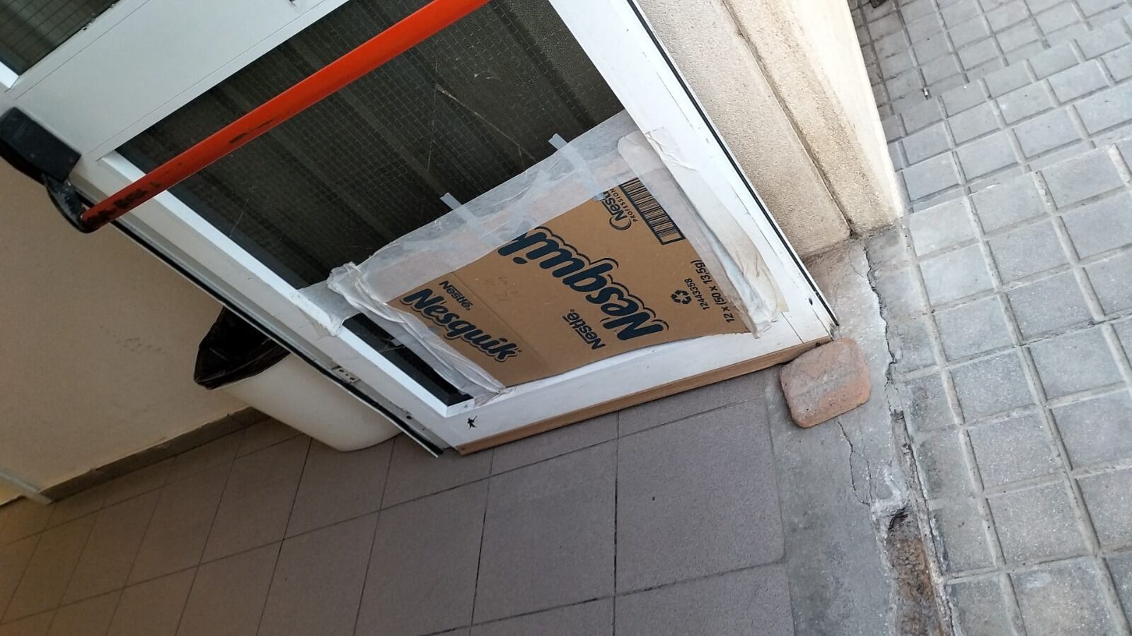 Puerta del pasillo de Salud Mental- zona de paso de pacientes y profesionales en una área en la que está restringido cualquier tipo de objeto cortante- cubierta con cartones tras romperse el cristal