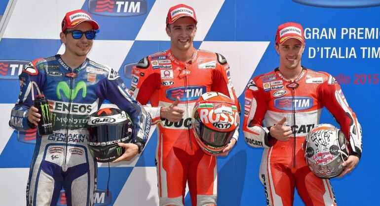 . Scarperia (Italy), 30/05/2015.- Italian MotoGP rider Andrea Iannone (C) of the Ducati Team celebrates after getting the pole position in the qualifying session at the Motorcycling Grand Prix of Italy at the Mugello circuit in Scarperia, central Italy, 3