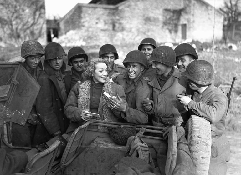 La actriz Marlene Dietrich rodeada de un grupo de soldados aliados en 1945