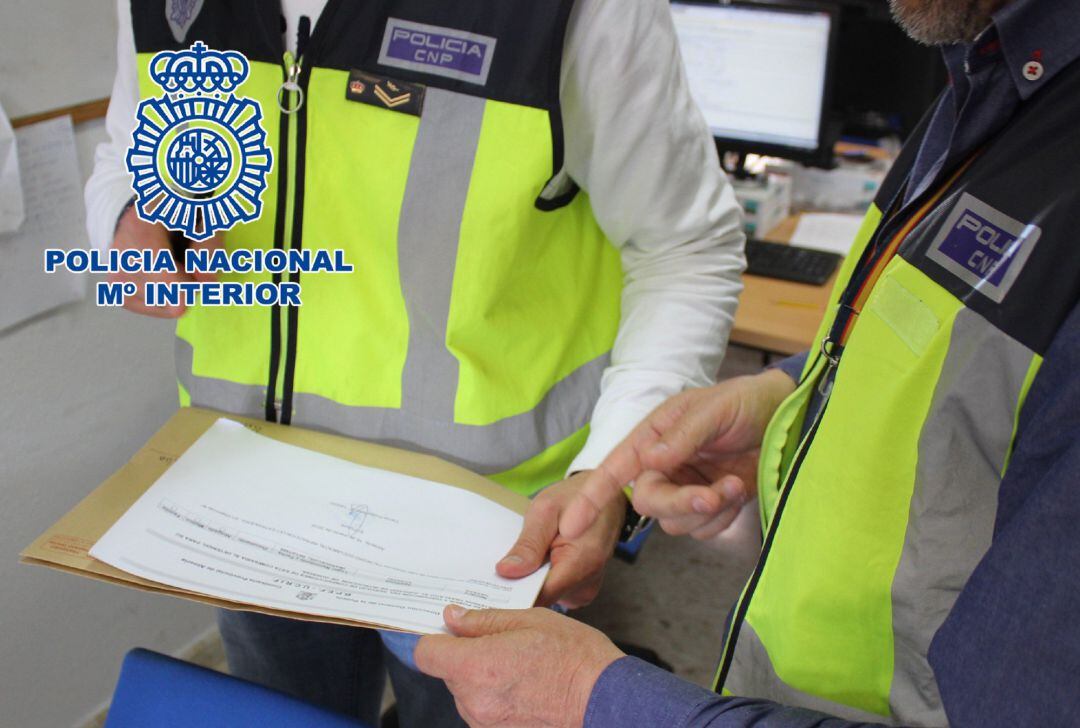 Agentes de la Policía Nacional revisan un contrato de alquiler fraudulento POLICÍA NACIONAL