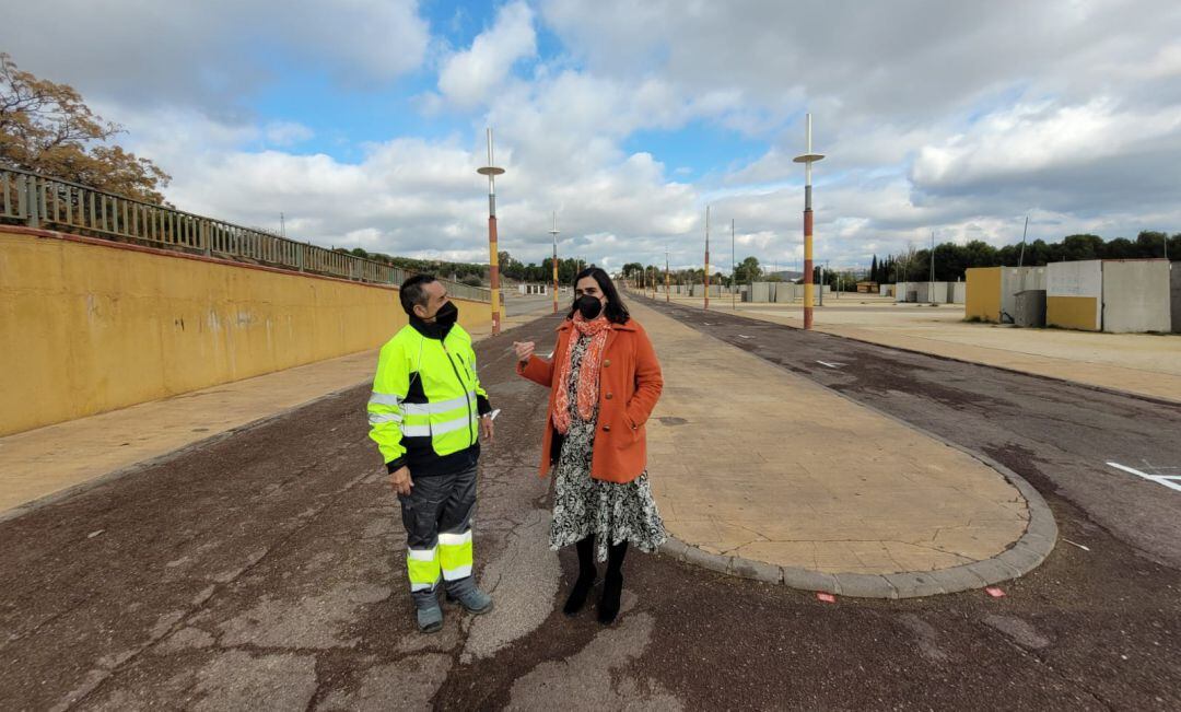 La concejala de Mercados, María Orozco, charla con un operario en el recinto ferial donde se celebra el mercadillo.