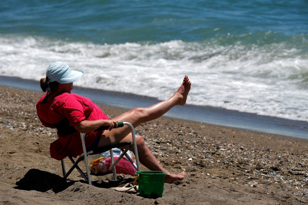 A woman sunbathes on La Malagueta beach, as some Spanish provinces are allowed to ease lockdown restrictions during phase three, amid the coronavirus disease (COVID-19)