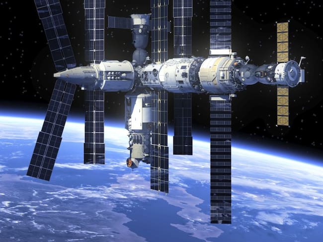 Imagen de la Estación Espacial Internacional y al fondo la imagen de la Tierra