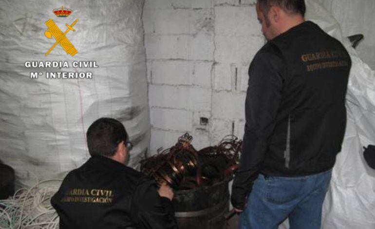 Dos agentes revisan el material incautado