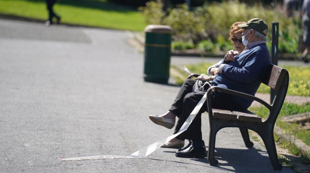 Una pareja disfruta del sol en un parque vasco