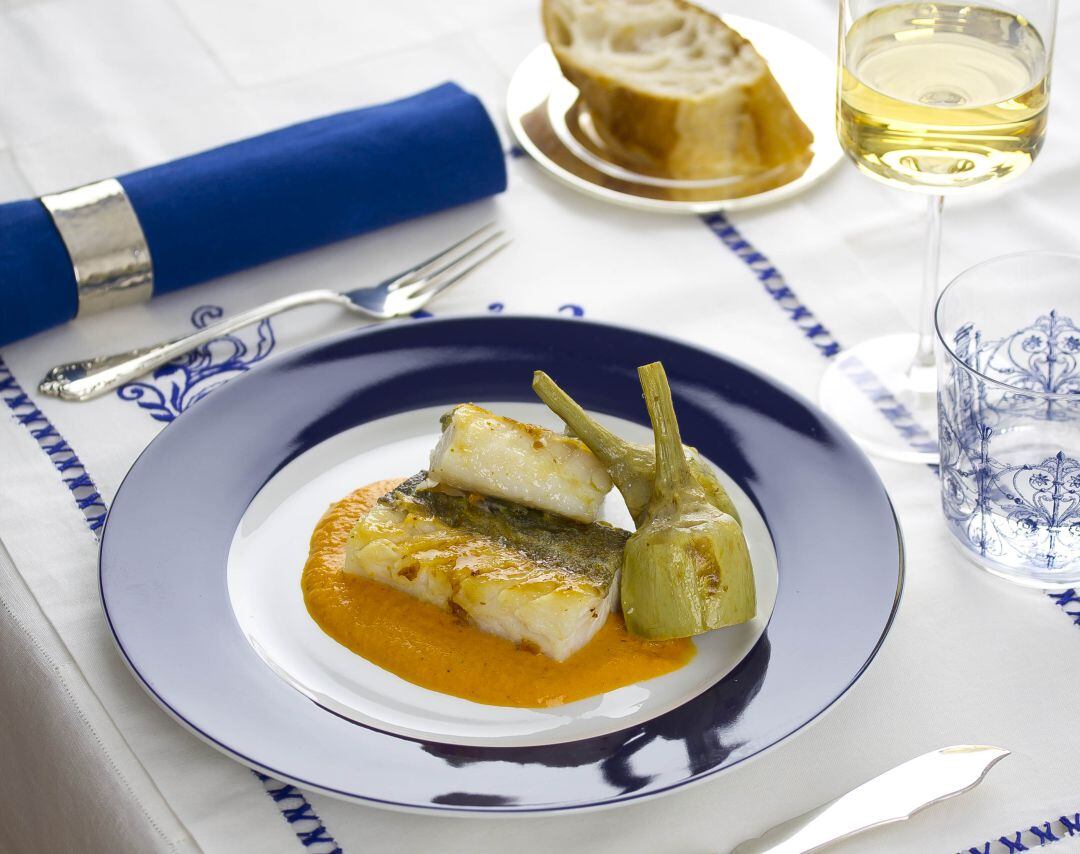 Presentación del plato de bacalao con salsa de pimientos.