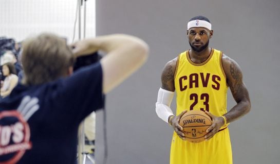 In this Sept. 26, 2014 photo, Cleveland Cavaliers&#039; LeBron James poses for Sports Illustrated photographer Al Tielemans during the NBA basketball team&#039;s media day in Independence, Ohio. With an undeniable hold on the NBA, James rules the league. He sets th