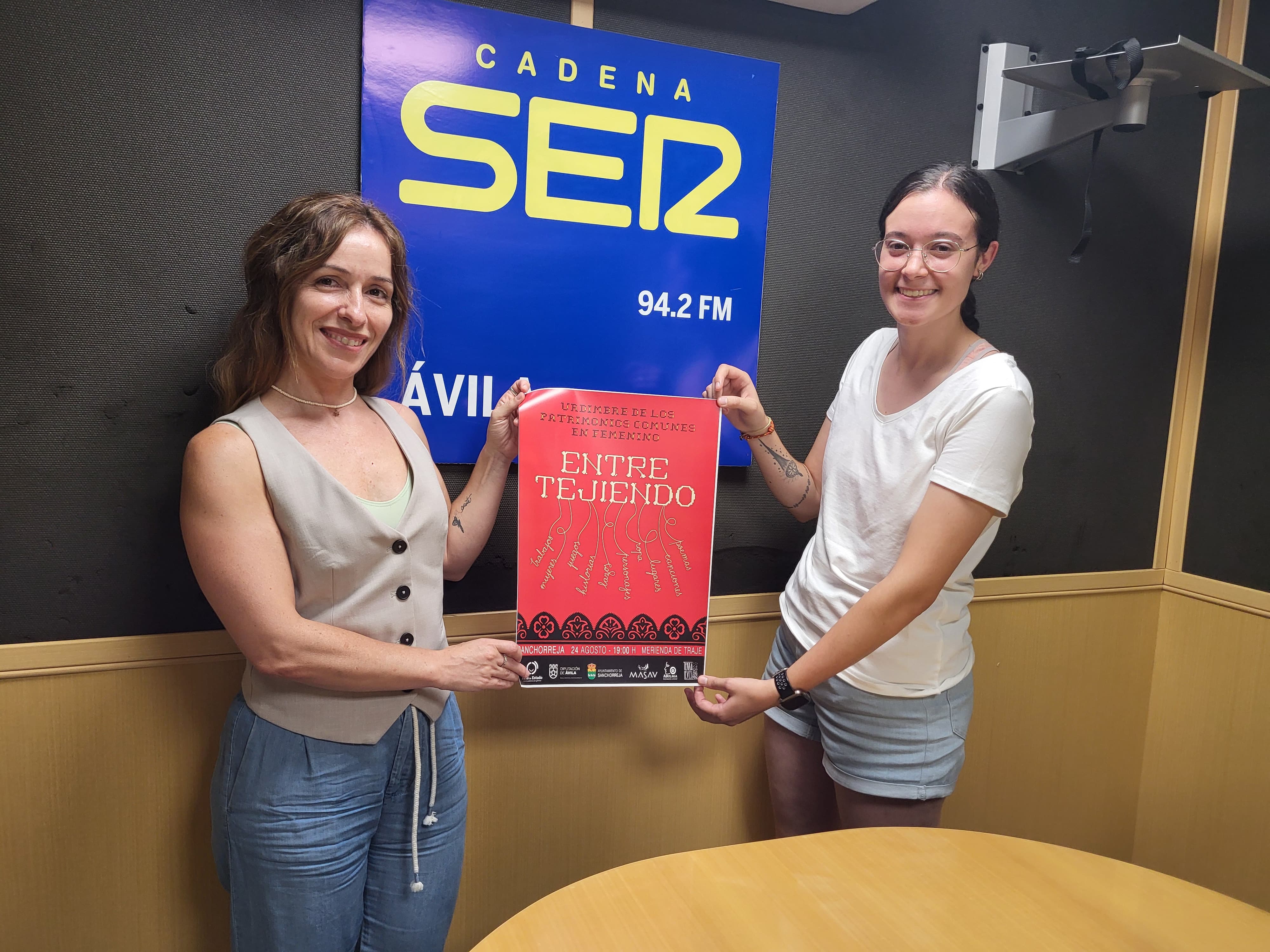 Rut López (Izq.) y Carlota Muñoz con el cartel del evento