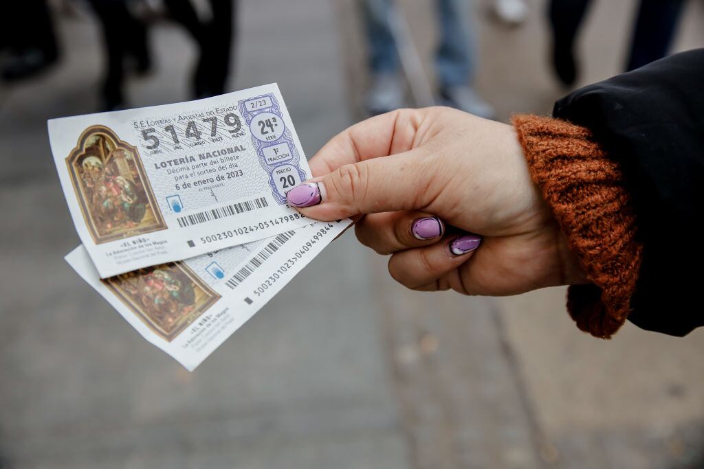 Una compradora muestra dos décimos del Sorteo del Niño.