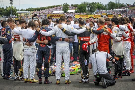 MTI118. Mogyorod (Hungary), 26/07/2015.- Formula One drivers embrace each other for a minute of silence to pay tribute to their recently deceased French colleague Jules Bianchi before the Hungarian Formula One Grand Prix on the Hungaroring circuit in Mogy