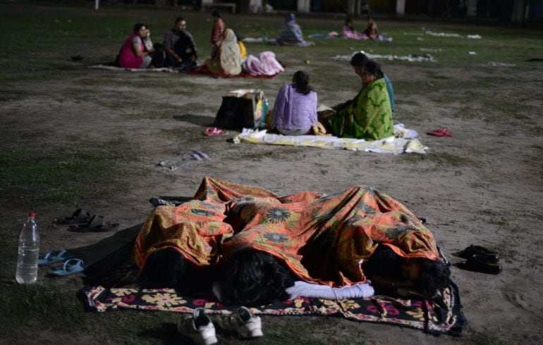 Indian residents rest and sleep in a football field in Siliguri on April 26, 2015 after a 7.8 magnitude earthquake hit the region on April 25 in Nepal. International aid groups and governments intensified efforts to get rescuers and supplies into earthqua