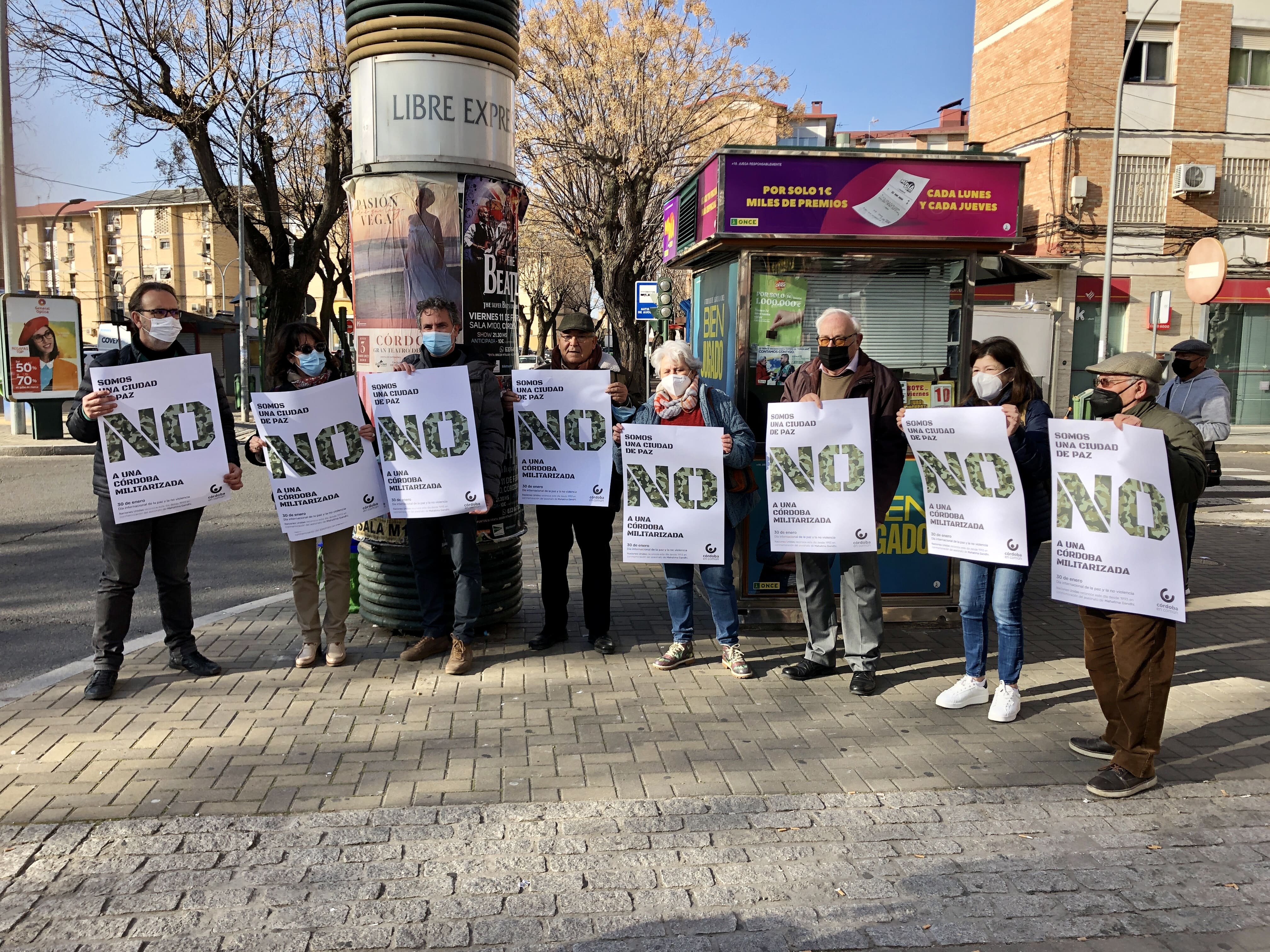 Militantes de Córdoba en Común expresan su rechazo a la Base Logística del Ejército de Tierra en Córdoba con una pegada de carteles con motivo del Día Internacional de la Paz