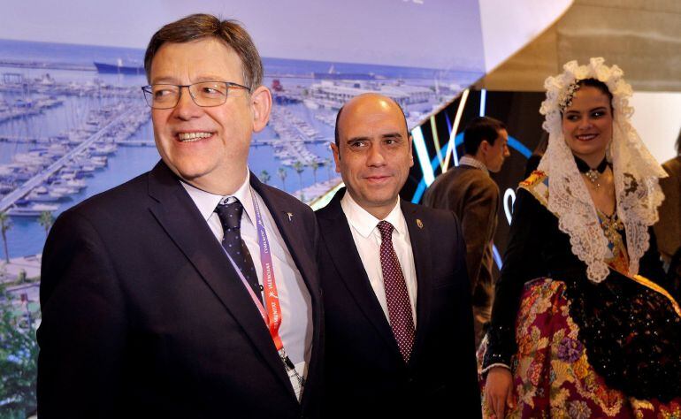 El president de la Generalitat, Ximo Puig (i), junto al alcalde de Alicante, Gabriel Echavarri, durante su visita a los diferentes expositores de los municipios de la Comunitat Valenciana en la Feria Internacional de Turismo (Fitur) de Madrid