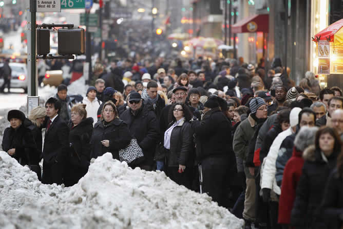 La nieve se mezcla con los viandantes que esperan el autobús en la Quinta Avenida de Nueva York