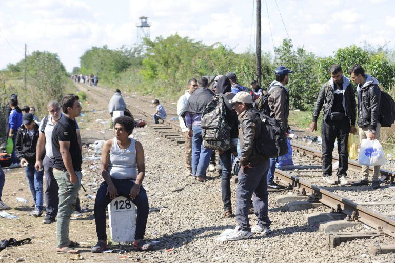 MTI119 ROSZKE (HUNGRÍA) 08/09/2015.- Refugiados que acaban de cruzar la frontera con Serbia esperan junto a las vías del tren cerca de Roszke (Hungría) hoy, 8 de septiembre de 2015. En el punto de reunión de Röszke, junto a la frontera con Serbia, donde los refugiados tienen que esperar horas y noches enteras antes de ser trasladados a los centros de registro, unos 300 inmigrantes decidieron ayer partir andando por la autopista que conduce a Budapest, pero la Policía los obligó a regresar. Durante el día se produjeron intentos de fuga y protestas por parte de los refugiados, que se quejan de que han de esperar mucho, algunos incluso al raso, a que termine el proceso de identificación. EFE/Zoltan Gergely Kelemen PROHIBIDO SU USO EN HUNGRÍA