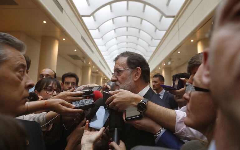 El presidente del Gobierno, Mariano Rajoy, atiende a la prensa antes de asistir a la sesión de control al Gobierno 