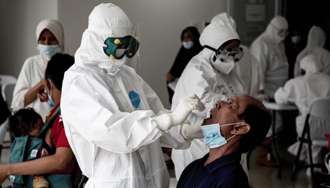  A health worker takes a PCR swab test from a man 