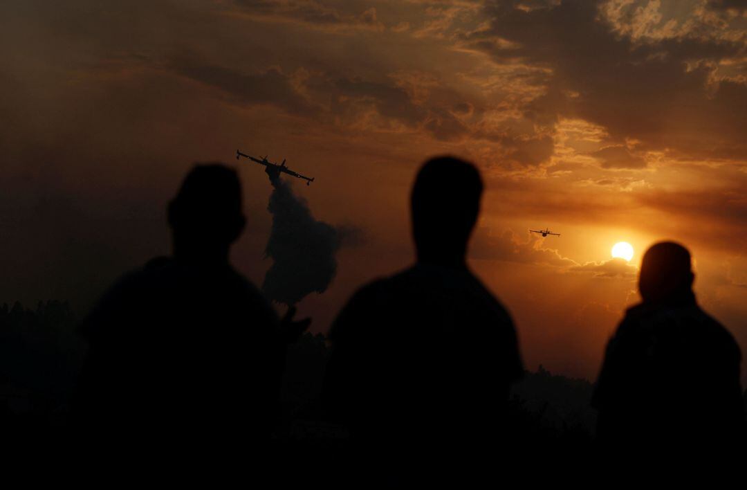 Un avión lanza agua sobre un incendio forestal en Chaveira (Portugal), el pasado lunes 22.