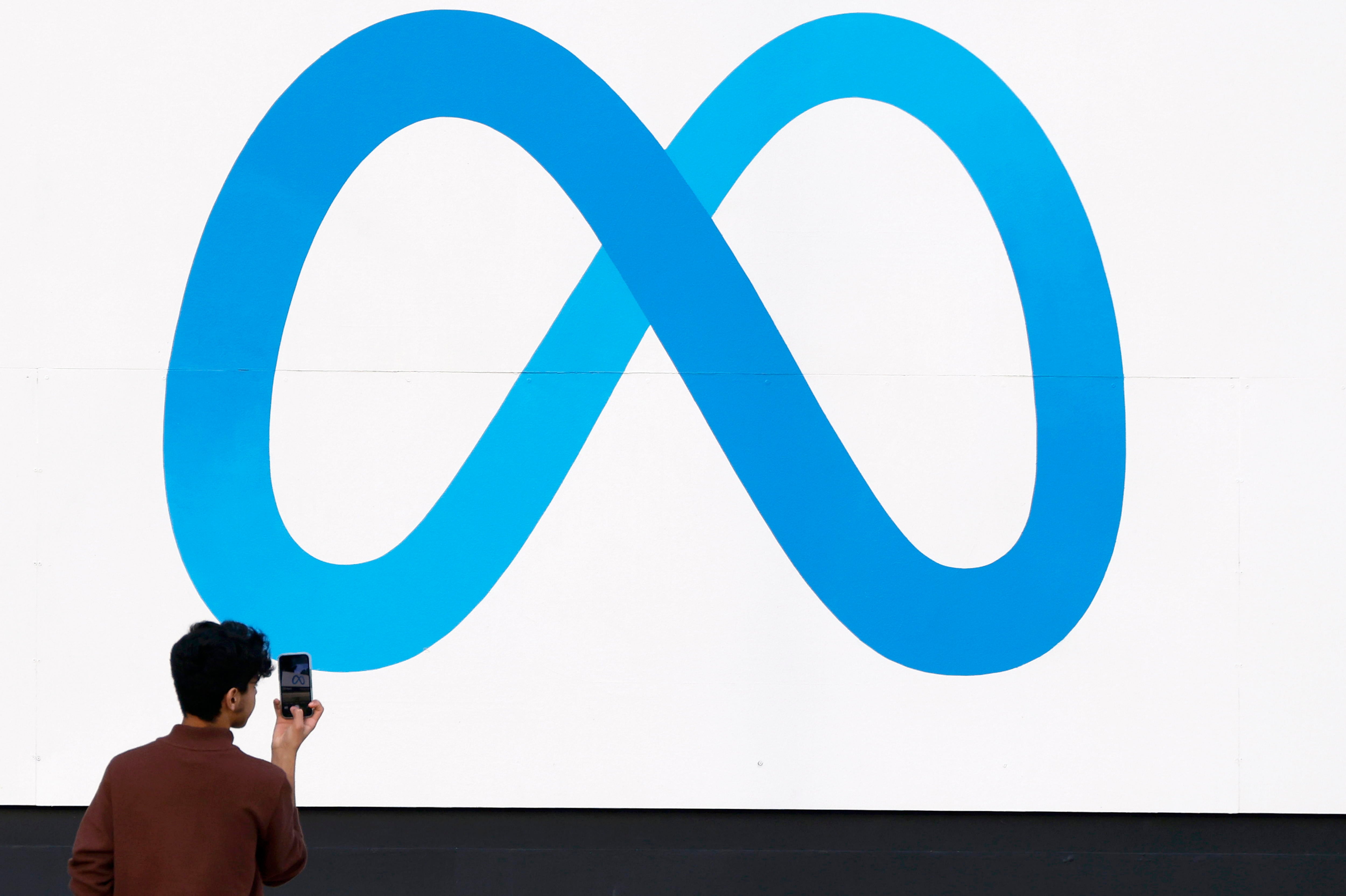 Fotografía de archivo del 7 de enero de 2025 de una persona tomando una fotografía al logo de Meta frente a la sede de la compañía en Menlo Park, California (Estados Unidos). EFE/ John G. Mabanglo ARCHIVO