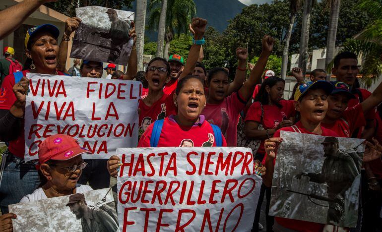 Un grupo de personas gritan consignas mientras hace fila para firmar un libro de condolencias por la muerte del líder cubano Fidel Castro en la sede de la embajada de Cuba hoy, lunes 28 de noviembre de 2016, en Caracas (Venezuela).