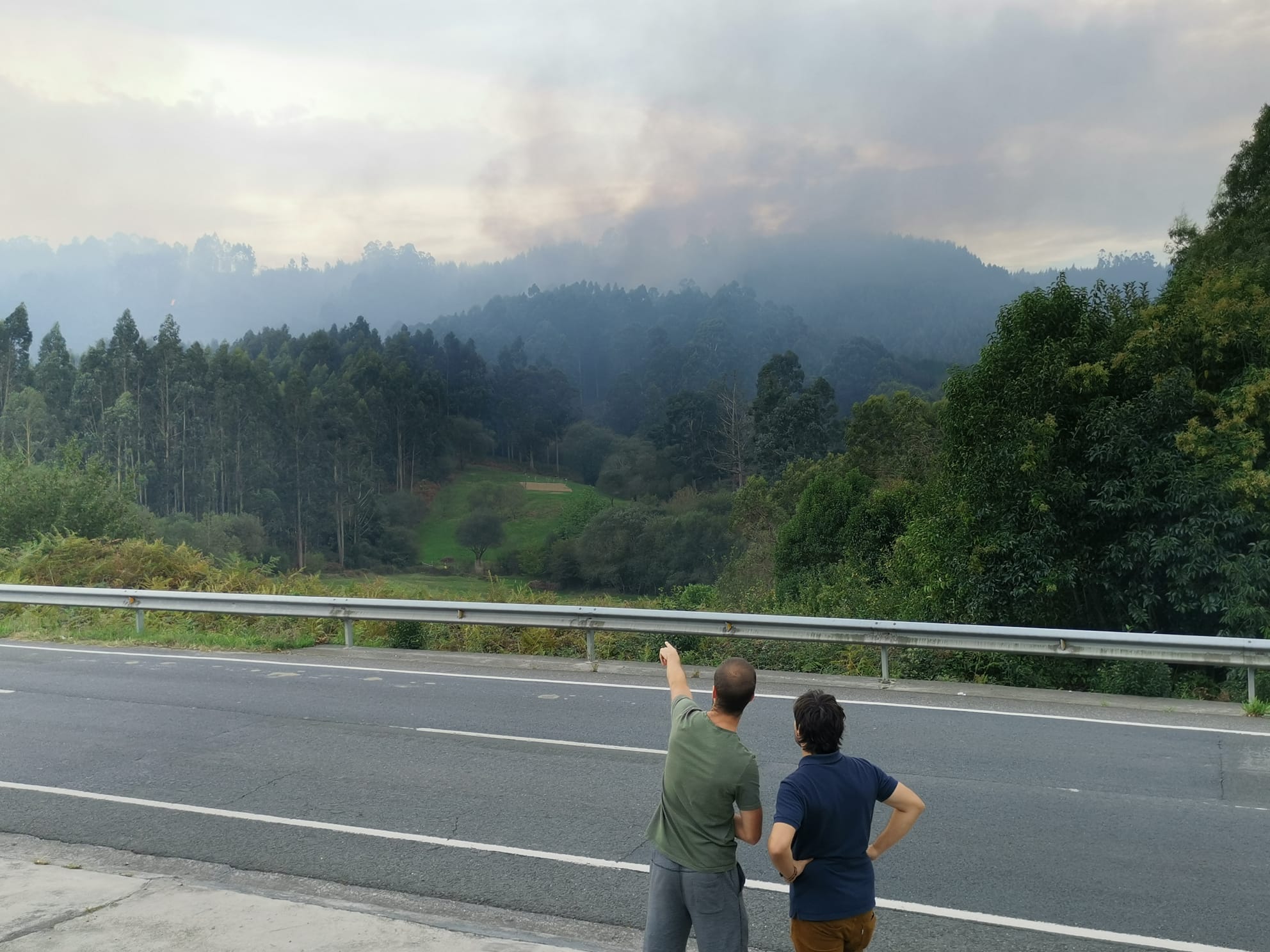 Unos vecinos observan el fuego desatado en La Arboleda esta mañana