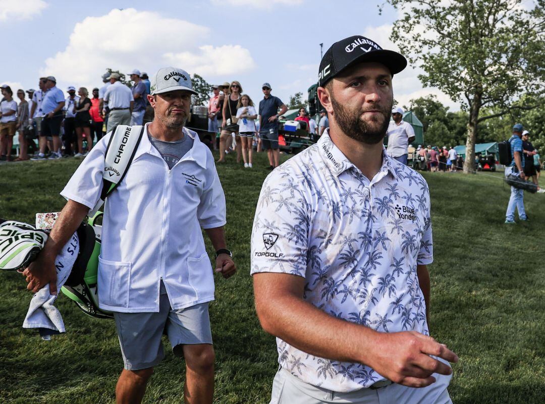 Jon Rahm of Spain (R) is followed by caddie Adam Hayes as they walk to the seventeenth tee during the third round of The Memorial golf tournament at Muirfield Village Golf Club in Dublin, Ohio, USA, 