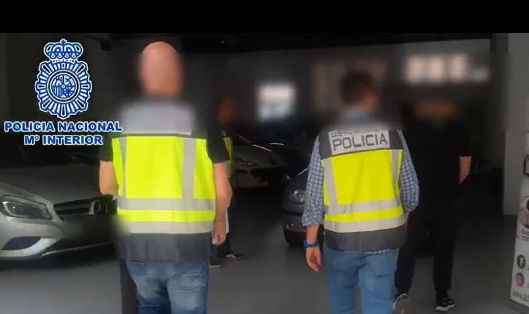 Agentes de la Policía Nacional durante el registro de una empresa de coches.