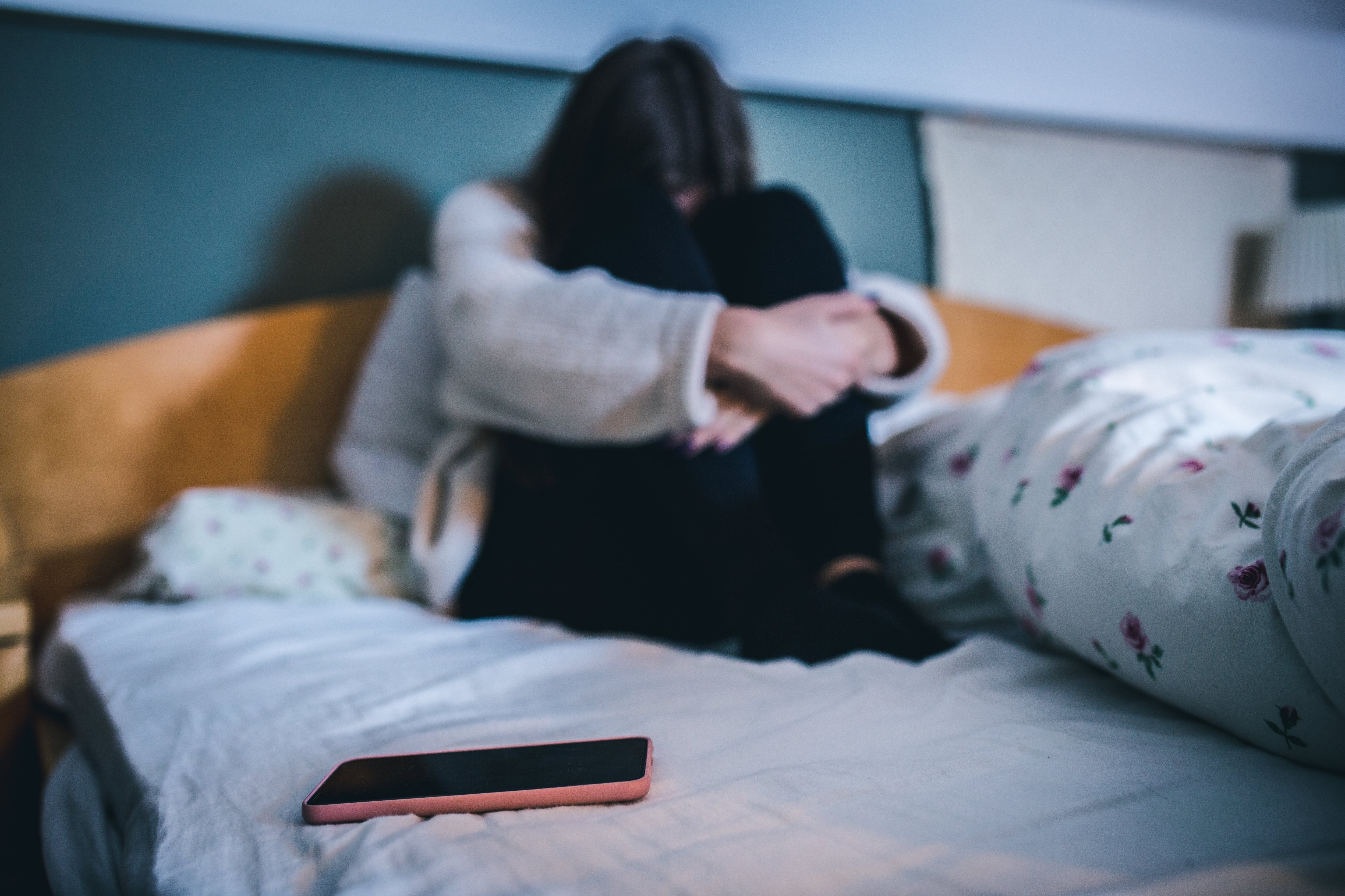 Teen with a phone in her bedroom