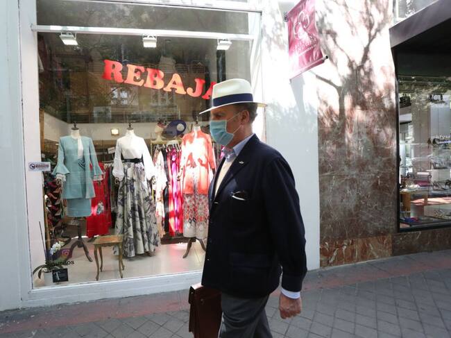 Un home protegit amb mascareta caminant pel carrer.