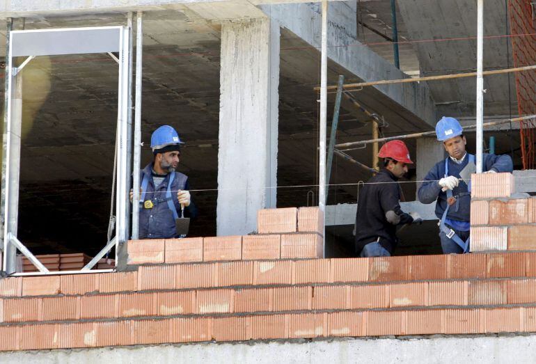 Tres obreros trabajan en la construcción de una vivienda. EFE/Archivo