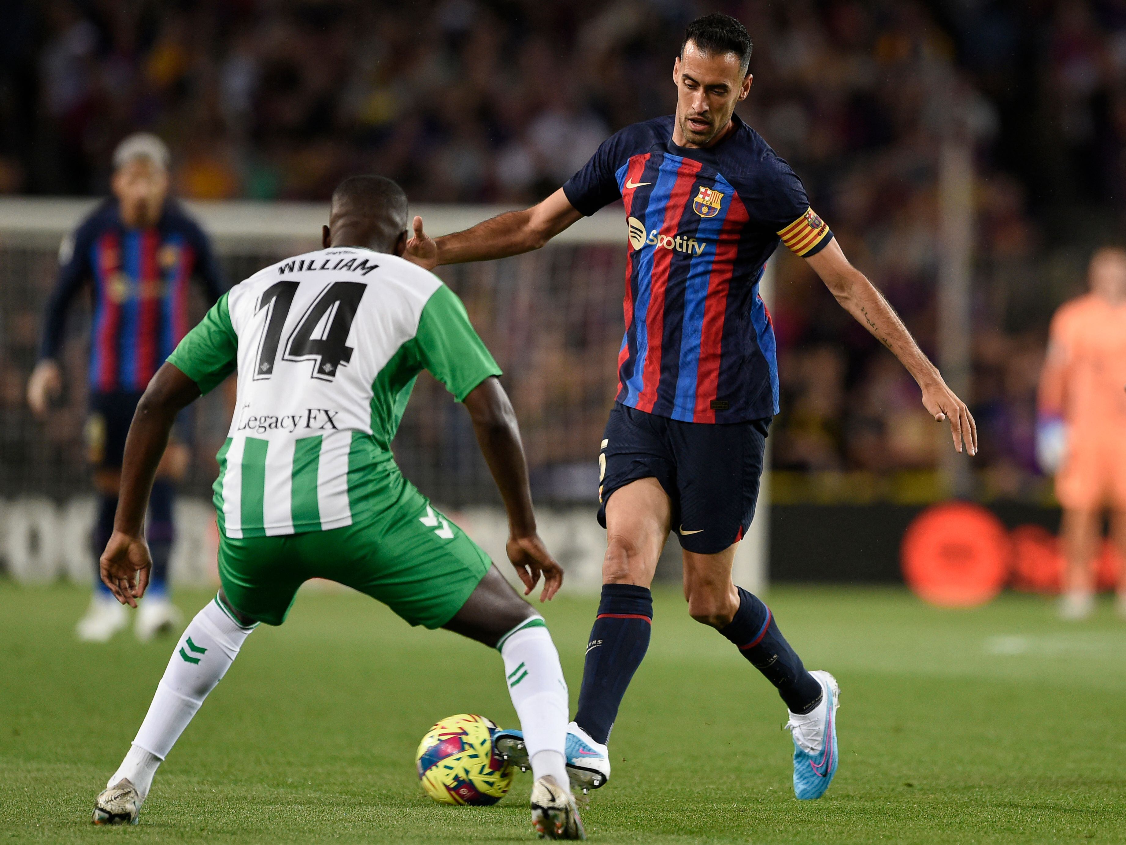 Spain's midfielder Sergio Busquets (R) vies with Real Betis' Portuguese midfielder William Carvalho during the Spanish league football match between FC Barcelona and Real Betis at the Camp Nou stadium in Barcelona on April 29, 2023. (Photo by Josep LAGO / AFP) (Photo by JOSEP LAGO/AFP via Getty Images)